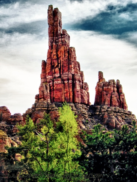 Red desert finger mountain against surreal dusk sky