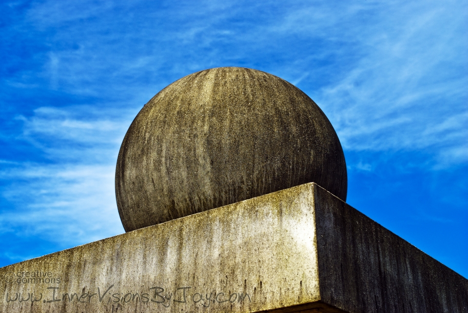 Stone sphere on plane against blue sky -- it's turtles all the way down!